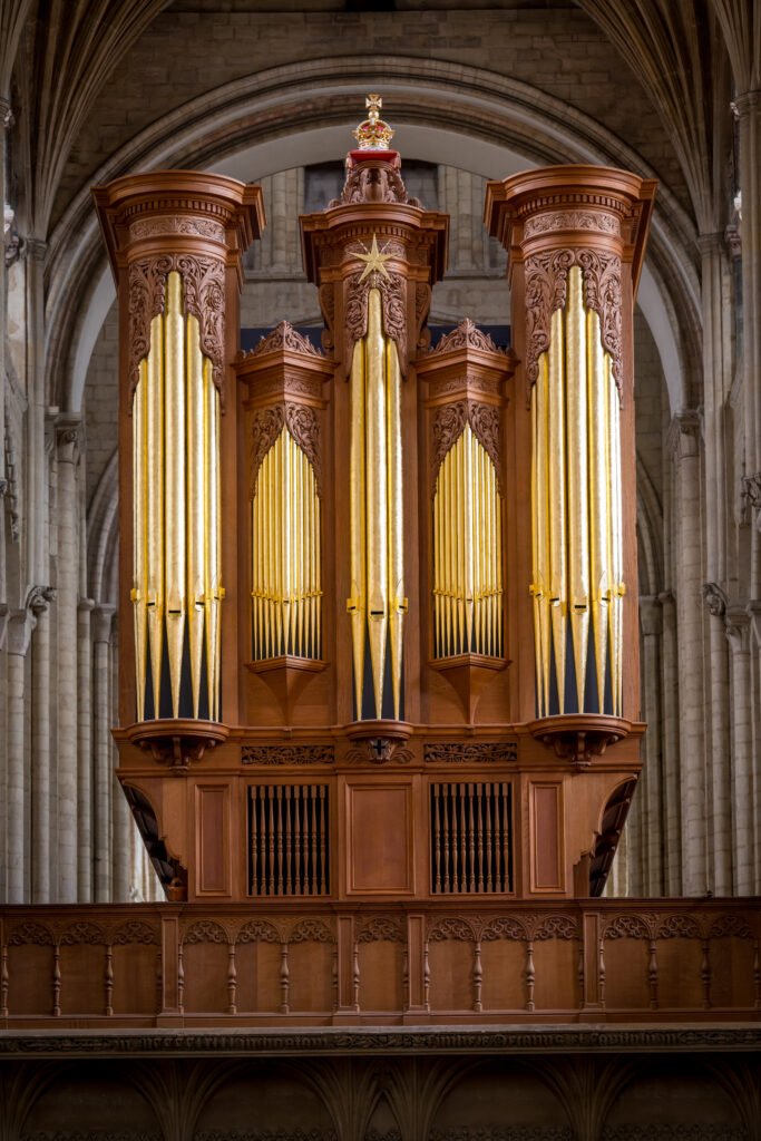 Photo of golden and wooden organ in cathedral