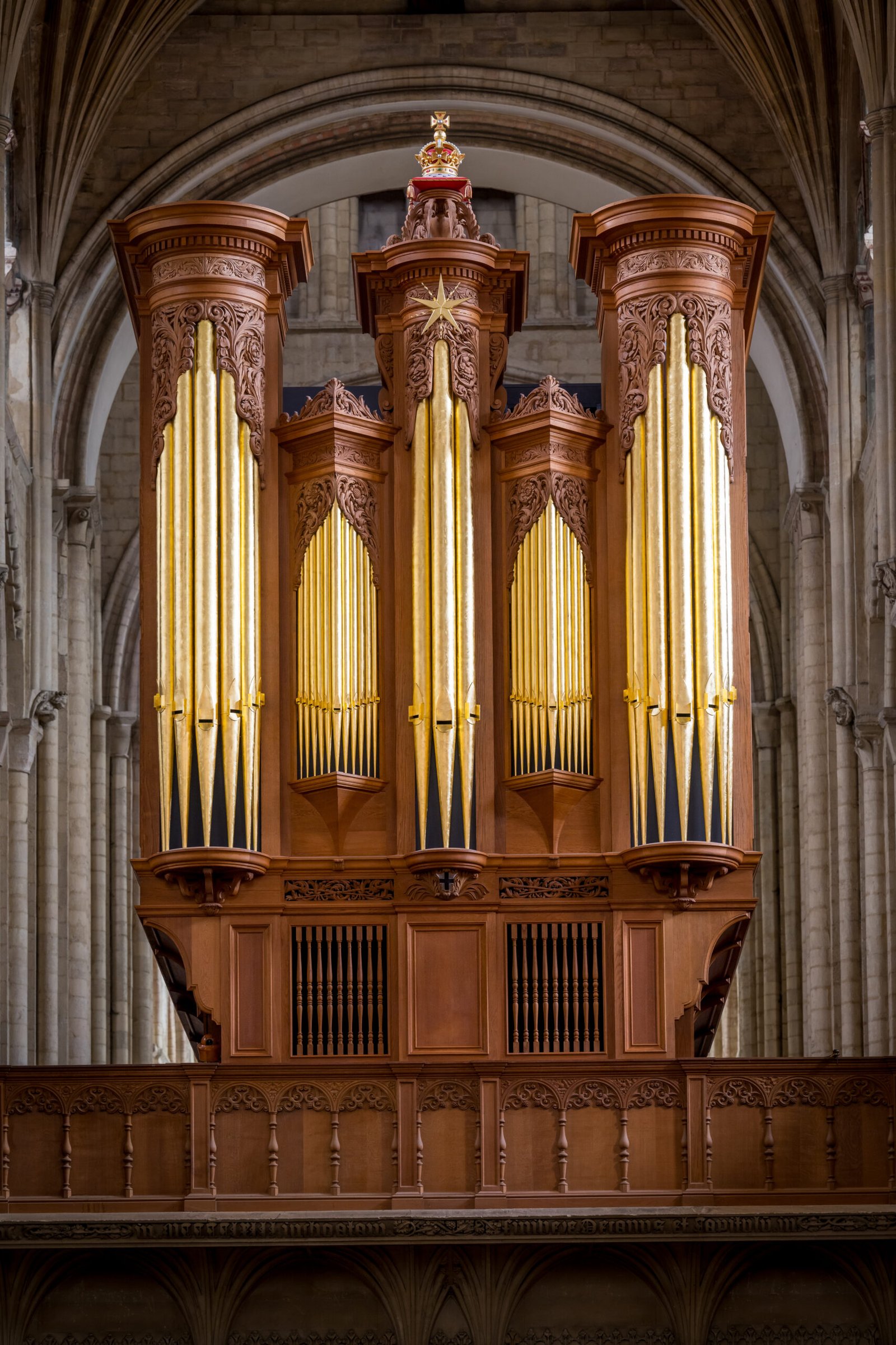 Photo of golden and wooden organ in cathedral